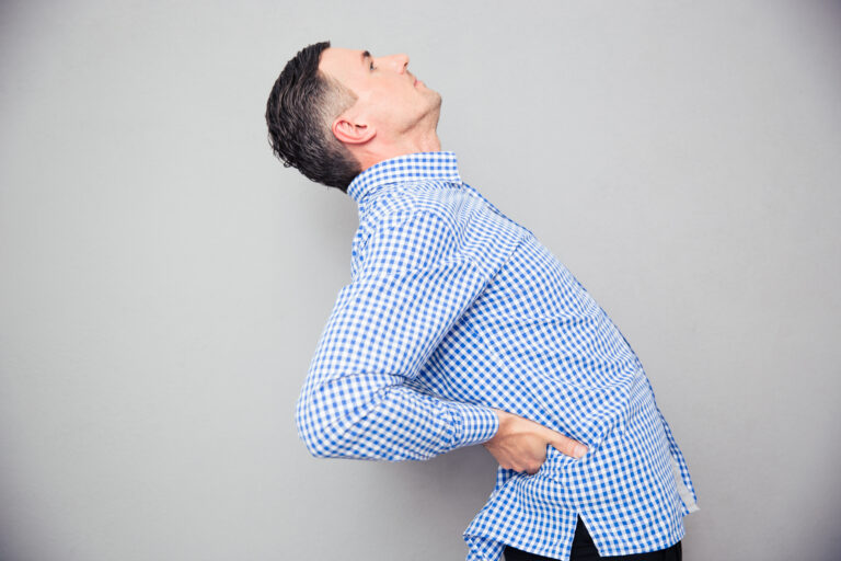 Man stretching back due to pain