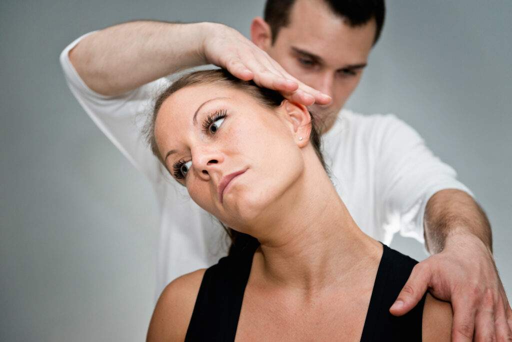 Man performing head alignment on woman