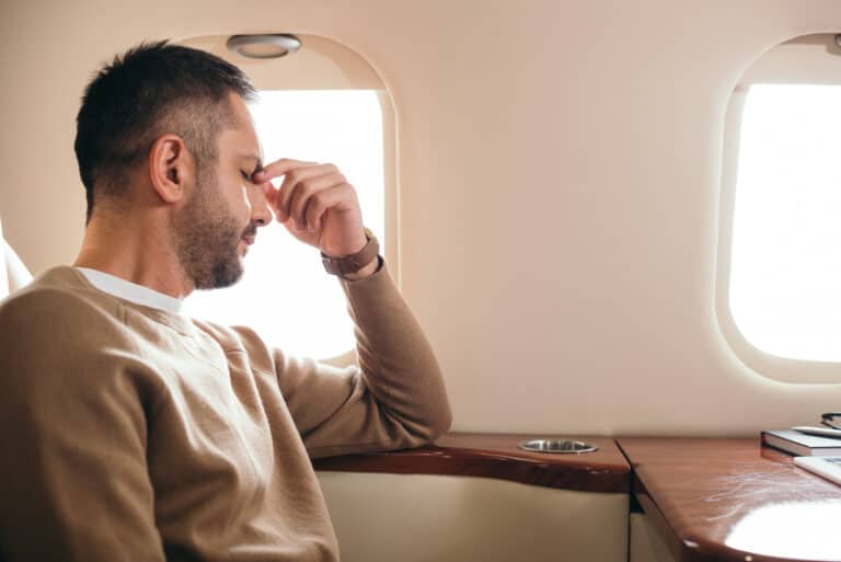 Man traveling in plane with vertigo